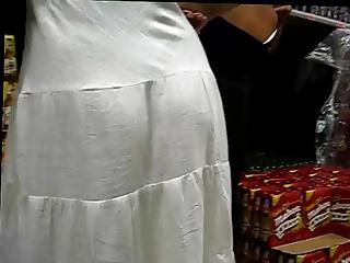 Brunette with white dress in the supermarket
